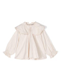 Blusa per bambina Donsje Mellys beige con dettagli ruches e colletto con pettorina – Accessorio premium elegante
